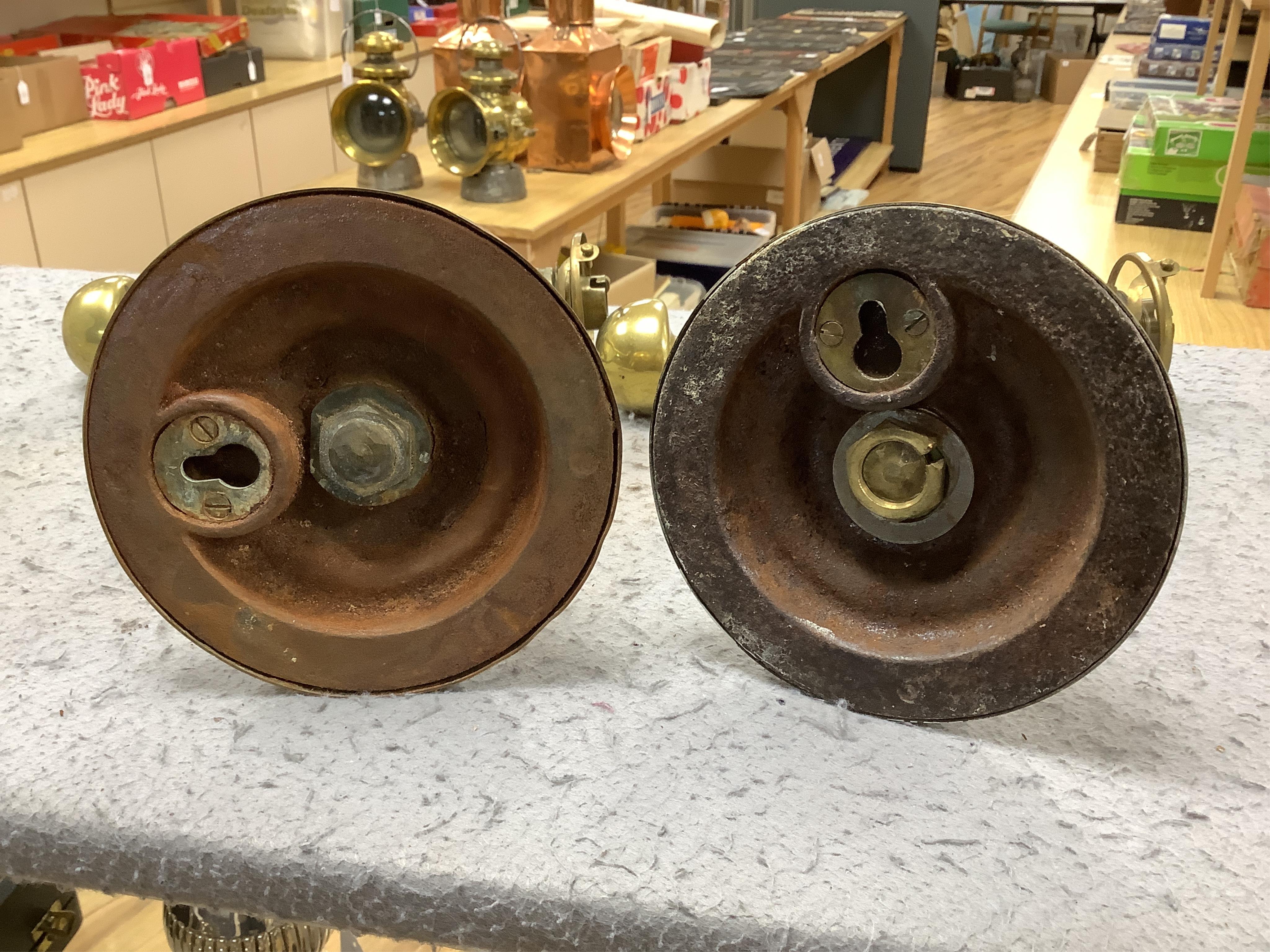 A pair of brass Pullman lamps with gimbal stems and Vaseline glass shades, modelled for wall mounting or freestanding, height to top of shade 40cm. Condition - good